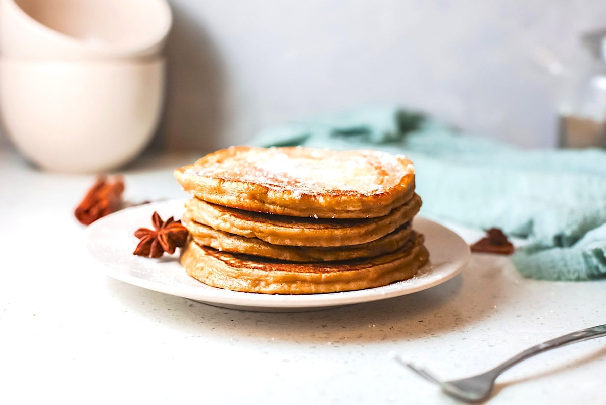 squash pancake on a white plate with a fork