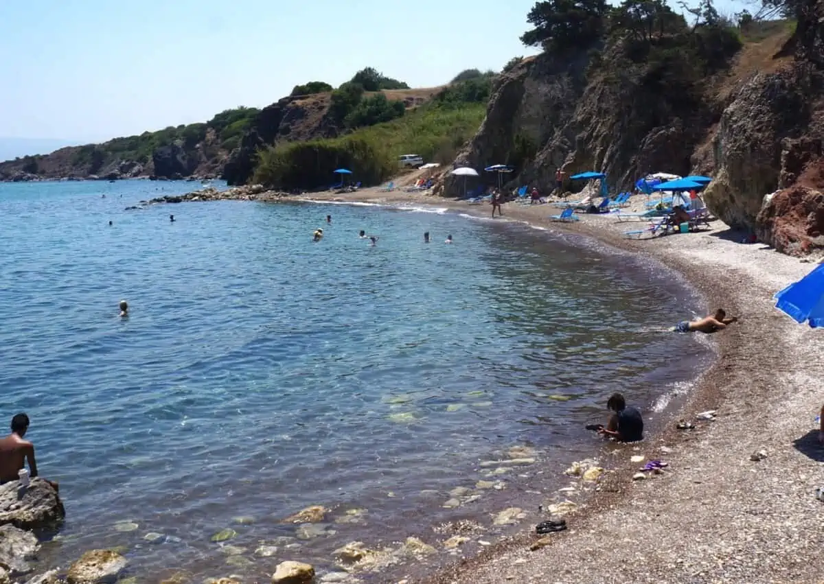 Pebbly beach and umbrellas at Aphrodite's Beach.