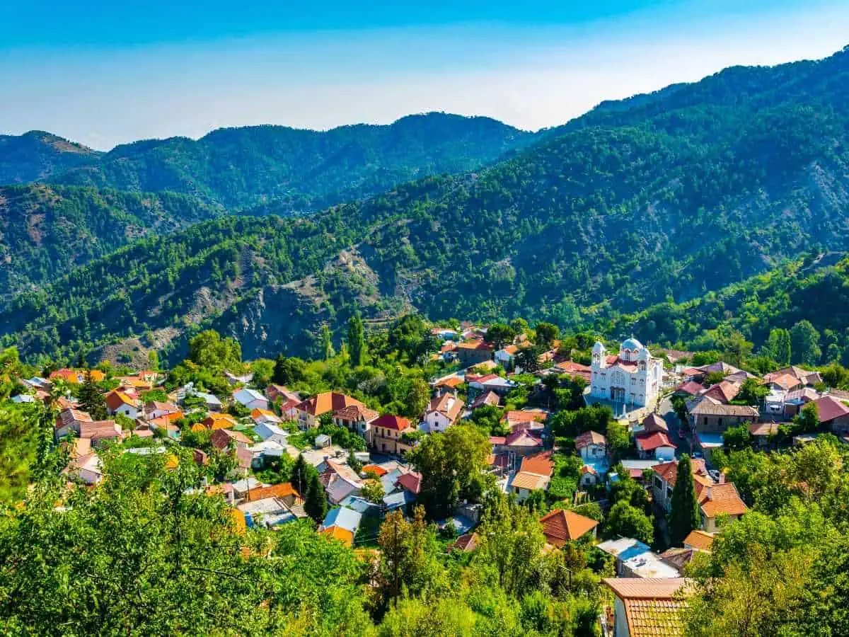 View of village with houses and mountains.