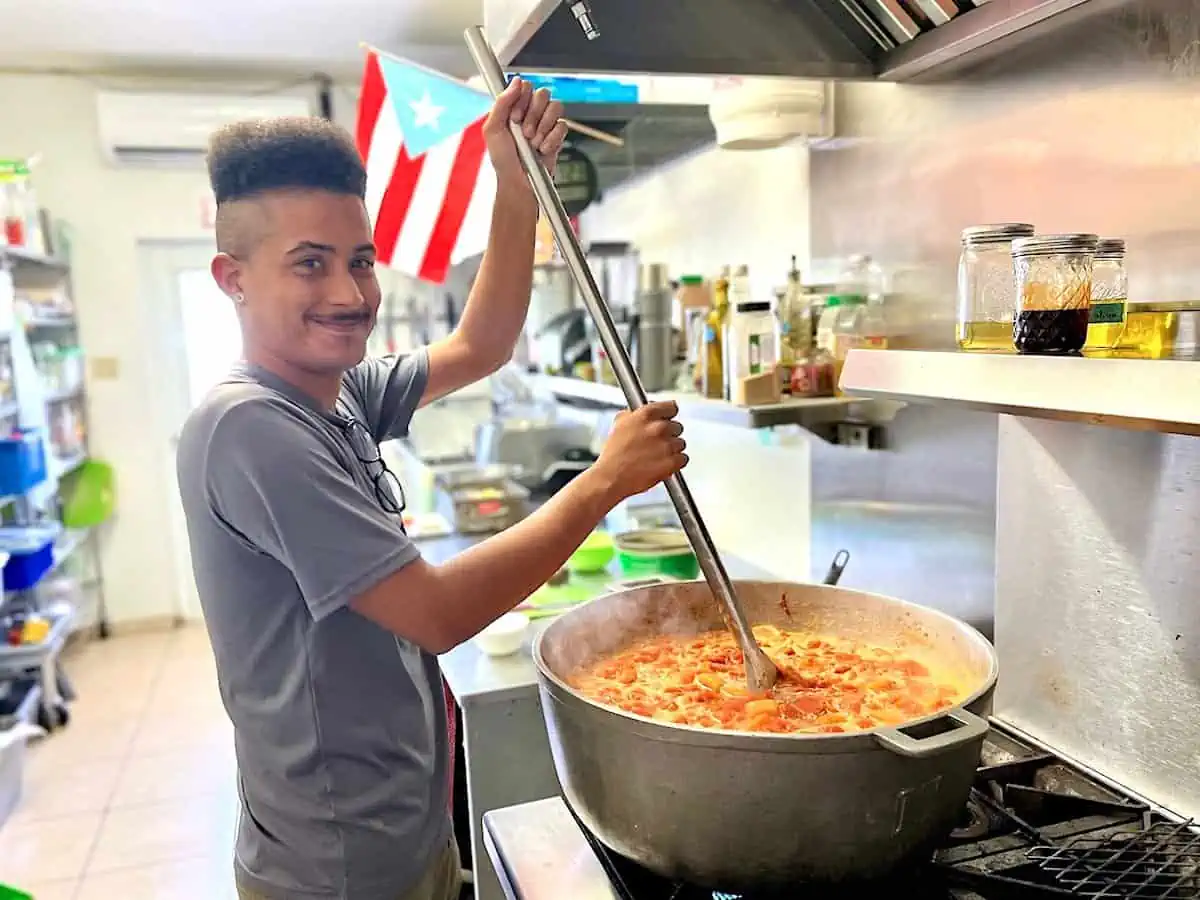 Adrian Rivera makes papaya and passionfruit marmalade in a large pot.