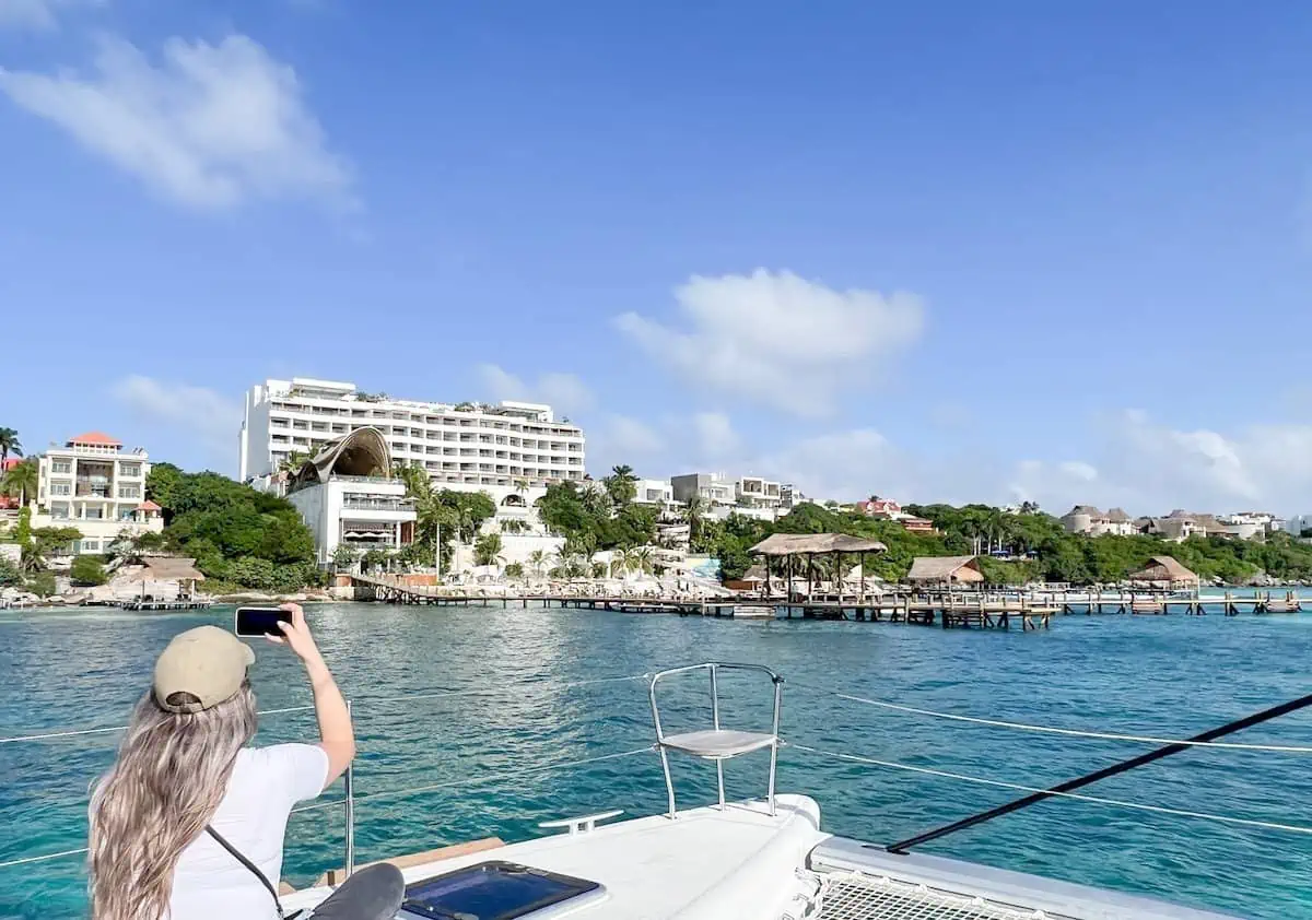 Woman taking a photo on a boat at Impression isla Mujeres. 