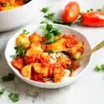 Bowl of bacalao salt cod stew on the table ready to eat.