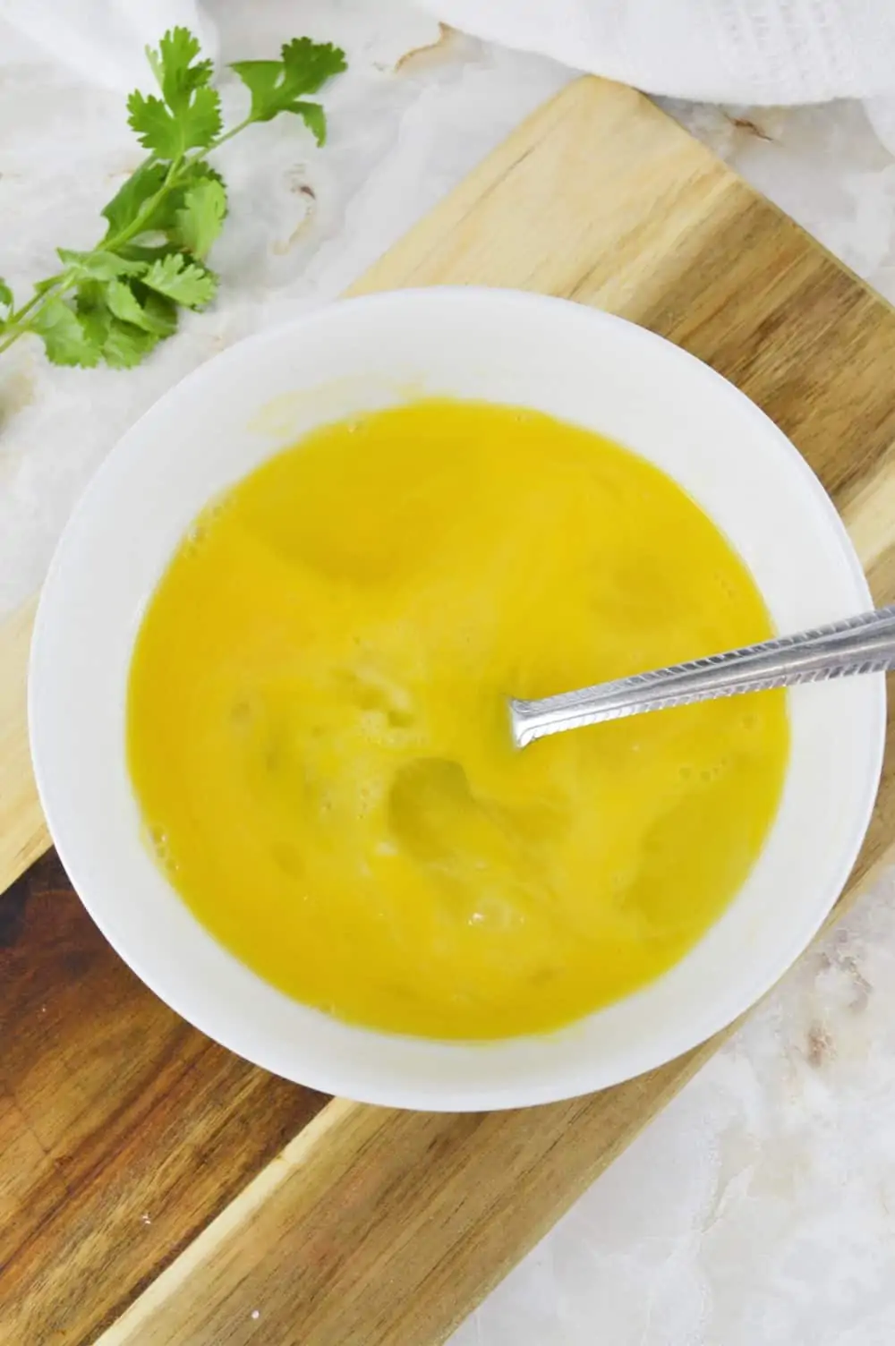 Beaten eggs in a bowl.