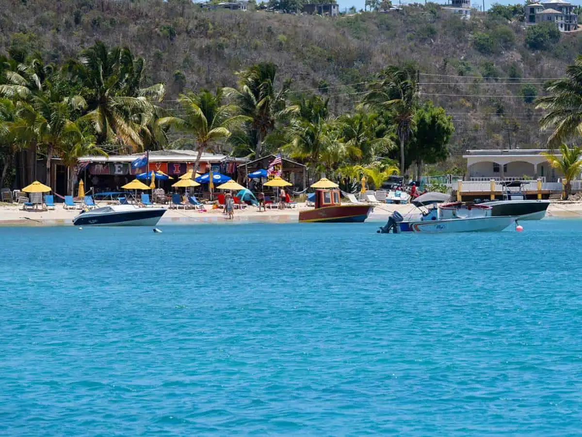 Boats in water in front of beach.