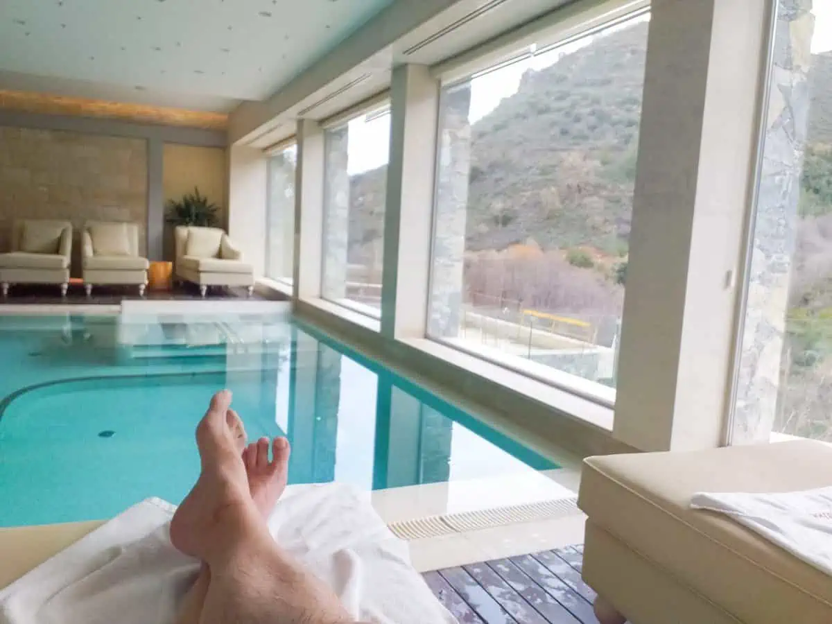 Man relaxing at a swimming pool at Casale Panayiotis Hotel and Spa, Cyprus. 