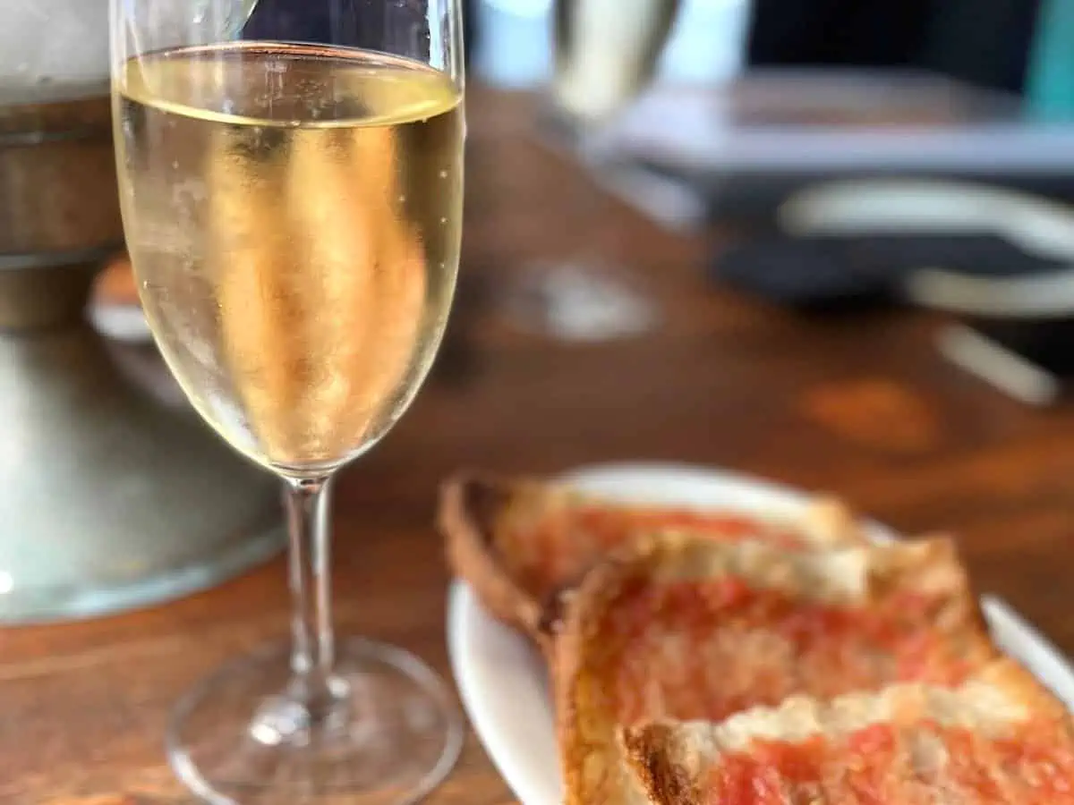 A glass of cava with pa amb tomàquet in a Barcelona restaurant.