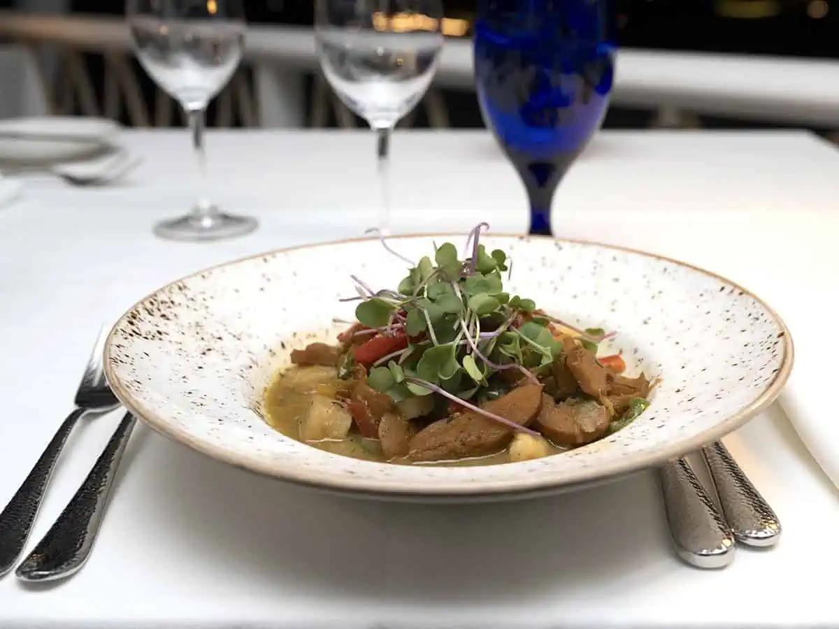 Plate of food in a white dish at Celeste at Malliouhana. 