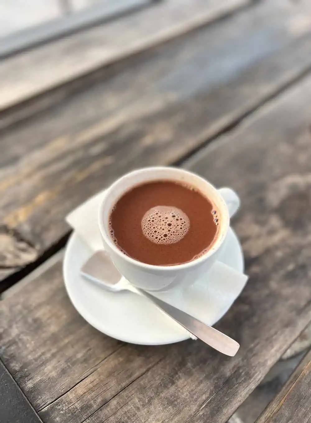 A white mug of hot ceremonial cacao, made with water, in La Antigua.  