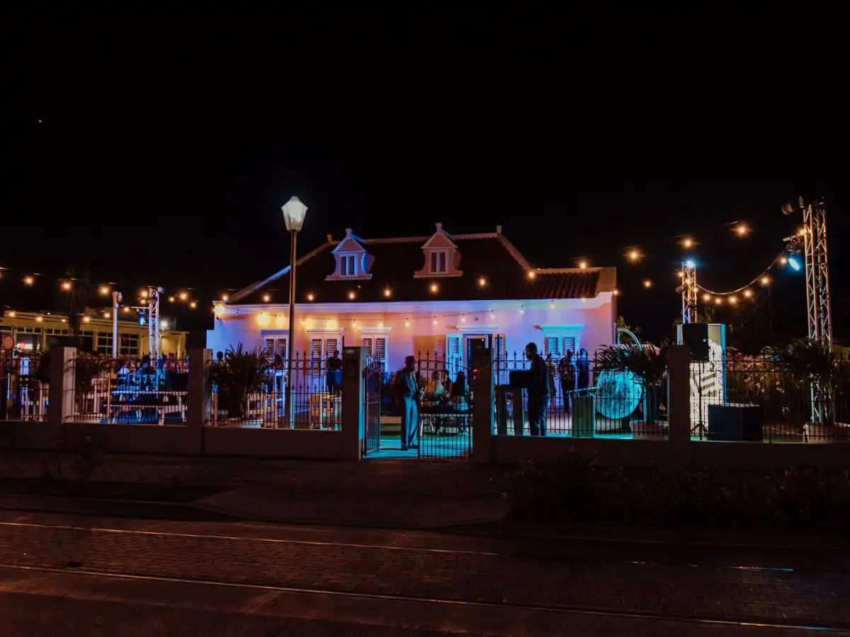 An outside view of a building in lights at night