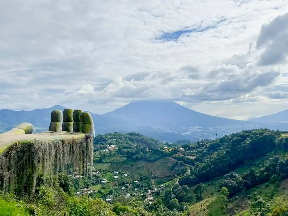 Giant Stone Troll Hand in Guatemala overlooking mountains and valley.