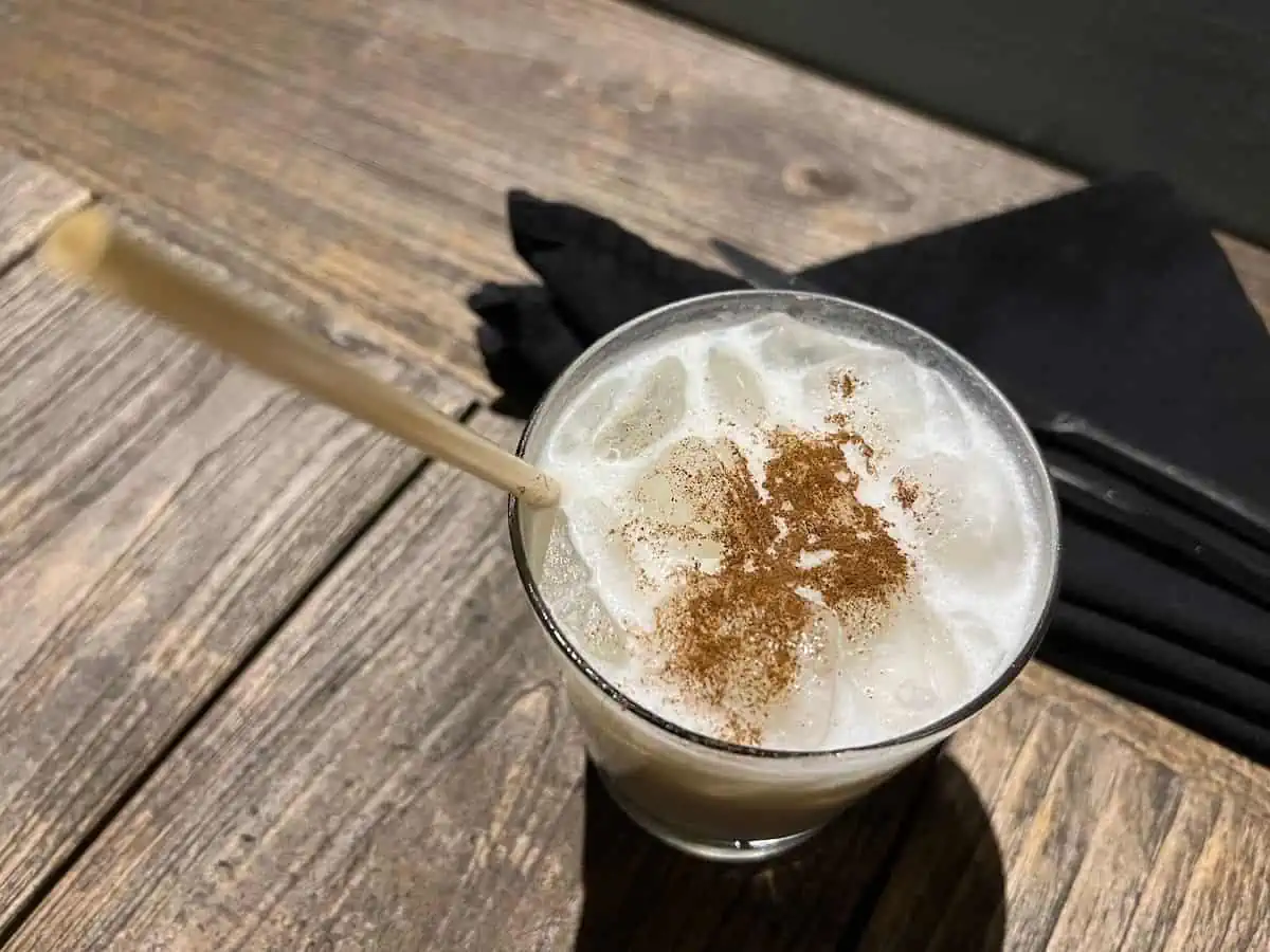 Gully Wash drink with straw on table. 