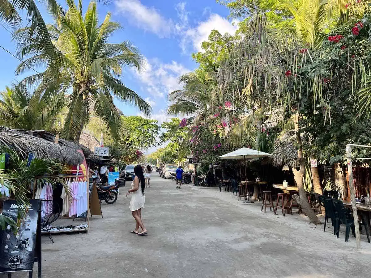 STreet view of palm trees and people in La Punta Puerto Escondido in 2023. 