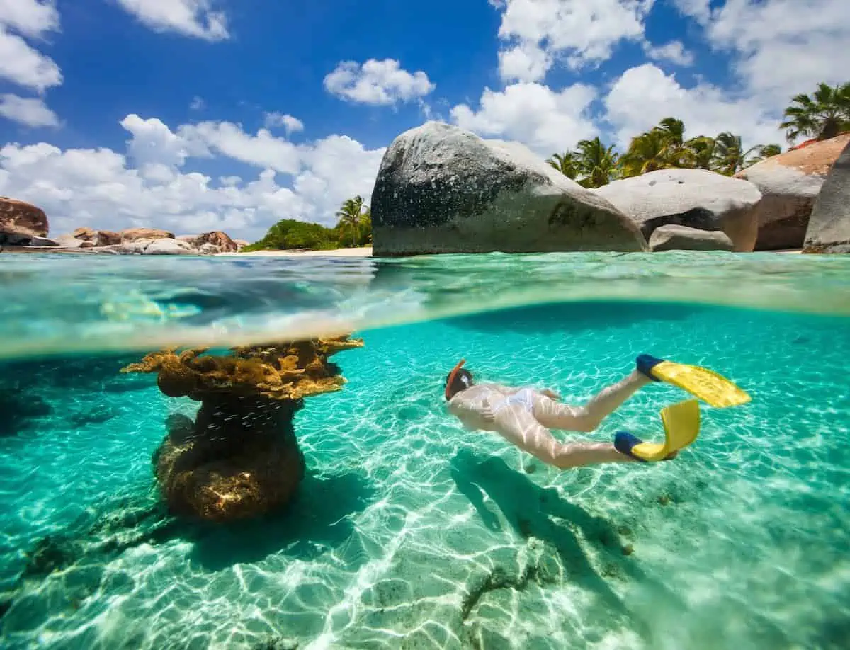 Woman snorkeling in turquoise waters of Virgin Gorda in BVI.