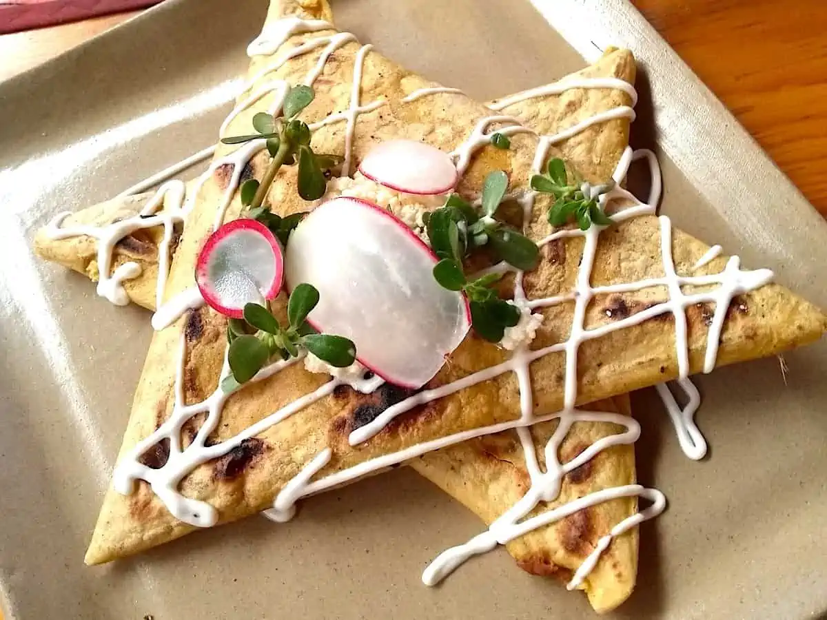 Oaxacan tetelas on a white plate.